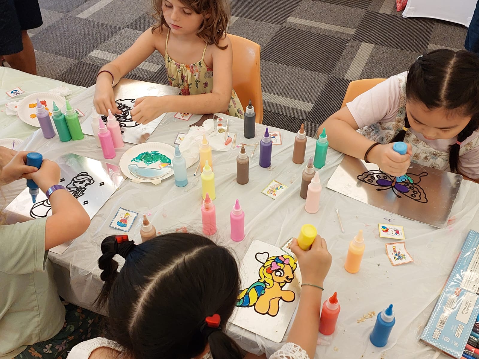 Children participating in glue art